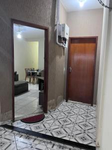 a hallway with a door and a living room at Andres' Home Vila Bretas in Governador Valadares