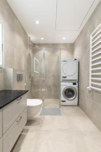 a bathroom with a washing machine and a washer at Bossa Nova - modern 2 bedroom apartment in the center in Vilnius