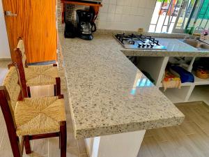 a kitchen with a counter top and a stove top oven at Hotel Valle in Zihuatanejo