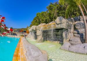 a pool at a theme park with a water slide at Vale Encantado - Eco Park & Hotel in Biritiba-Mirim
