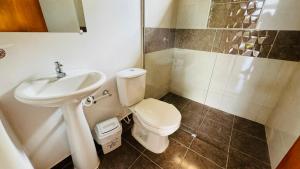 a bathroom with a toilet and a sink at Piedras del Sol Casa Campestre in Guaduas +17 photos