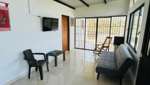 a living room with a couch and a table and chairs at Piedras del Sol Casa Campestre in Guaduas