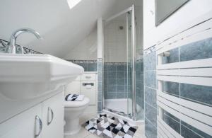 a bathroom with a toilet and a shower and a sink at Serene 4BR House with Garden & Conservatory in Nottingham