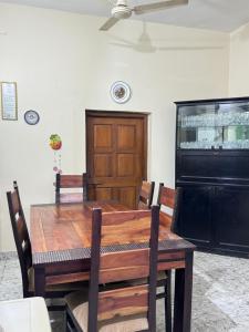 a dining room table with chairs and a ceiling fan at Villa Almeida in Panaji