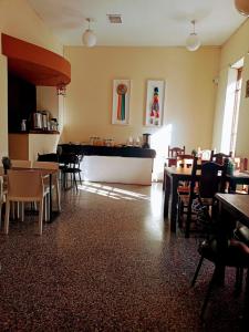 a restaurant with tables and chairs and a piano at Hotel inty raimi in Salta