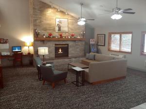 a living room with a couch and a fireplace at AmericInn by Wyndham Dickinson in Dickinson