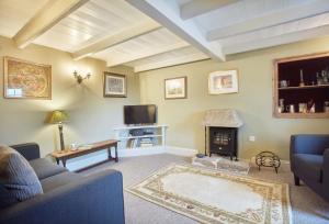 a living room with a couch and a fireplace at Prospect House in Coverack