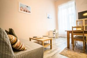 a living room with a couch and a table at Entire Flat in Kecskemét Center in Kecskemét