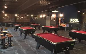 a row of ping pong tables in a pool room at L'Escale Orléanaise in Orléans