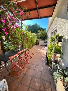 a patio with a picnic table and flowers at Green Door Apartment in Limassol