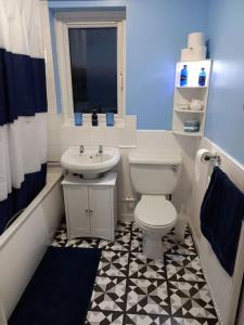 a bathroom with a white toilet and a sink at Twin room in Prescot Homestay in Prescot