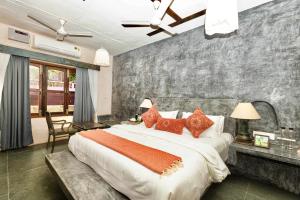 a bedroom with a large bed with red pillows at GERANIUM HAVEN in Arambol