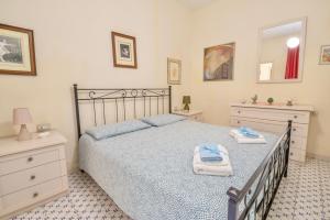 a bedroom with a bed with two towels on it at Bilocale vista mare al Castello in Piombino