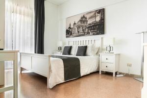 a white bedroom with a large bed and a window at Aulino House in Catania +42 photos