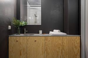a bathroom with a sink and a mirror at Comfy Studio easy to commute in Stockholm