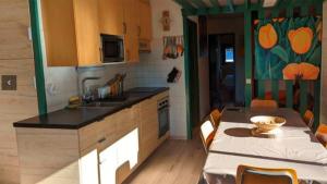 a kitchen with a table and a kitchen with a table and a tableablish at Appartement- Villard de Lans-8 pers in Villard-de-Lans