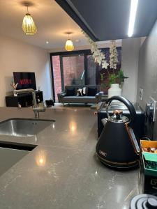 a kitchen with a tea kettle on a counter at Richardson Deluxe Apartments - 3 Bed in London