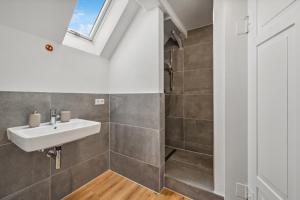 a bathroom with a sink and a shower at home2stay worker Apartments Metzingen in Metzingen