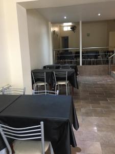 a group of tables and chairs in a room at Carlos VII in Mar del Plata