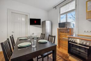 a kitchen with a table with chairs and a stove at home2stay worker Apartments Metzingen in Metzingen