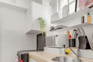 a kitchen with a sink and a counter top at The Covent Courtyard Flat in London