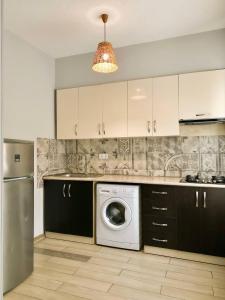 a kitchen with a washing machine and a washer at Memories House in Bakuriani +17 photos