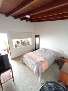a bedroom with a bed and a tv in it at Espacio seguro, amplio y acogedor in Medellín