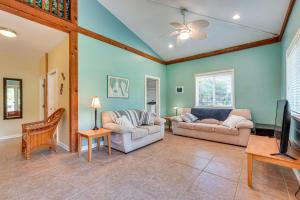 a living room with two couches and a flat screen tv at Peaceful Naalehu Paradise 5 Mi to Beach! in Naalehu