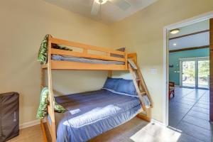 a bedroom with bunk beds in a house at Peaceful Naalehu Paradise 5 Mi to Beach! in Naalehu