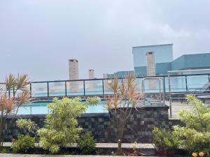 um edifício com piscina e algumas árvores em Studio em Florianópolis