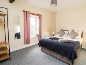 a bedroom with a large bed and a window at Afonwy House in Rhayader
