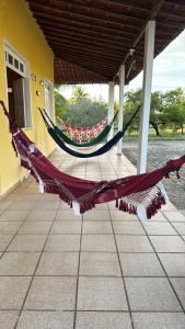 a hammock on the porch of a house at Chácara in Estância