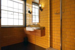 a bathroom with a sink and a glass shower at The Southern Belle in Brighton & Hove