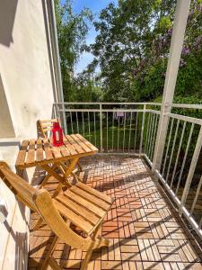 a patio with a table and chairs on a balcony at Prorsus Design Apartments in Leipzig