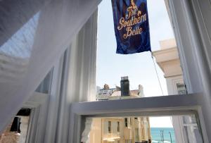 a view through a window of a building with a sign at The Southern Belle in Brighton & Hove