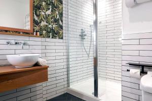 a bathroom with a sink and a shower at The Southern Belle in Brighton & Hove