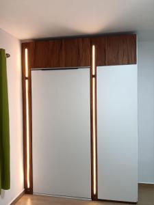 a closet with two doors in a room at J&J in Centre de Flacq