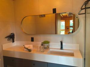 a bathroom with a sink and a mirror at Villa Lucca in Urubici