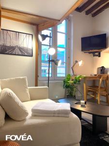 a living room with a couch and a table at Arés in Caen