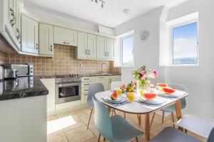 a kitchen with a table with fruit on it at UpperDeck, Salcombe (Free Parking) in Salcombe