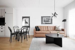 a living room with a couch and a table at Contemporary 2-BR with Workspace in Kottla