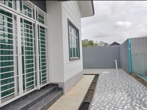 een wit gebouw met een raam en een hek bij Aida homestay Kuala terengganu/Kuala nerus in Kuala Terengganu