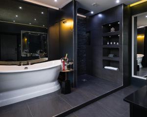 a bathroom with a tub and a shower at The Old Manse of Blair, Boutique Hotel & Restaurant in Blair Atholl