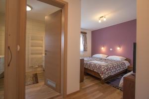 a bedroom with a bed and a bathroom at Tourist farm Megušar in Škofja Loka +62 photos