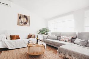 a living room with a couch and a table at Casa La Martina Frigiliana in Frigiliana +43 photos