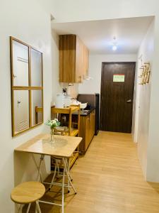 a kitchen with a table and a dining room at EZ Cityscape Studio at Loop Towers Limketkai in Cagayan de Oro +8 photos