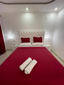a bedroom with a large bed with two towels on it at Queen Kodre Apartments in Ulcinj