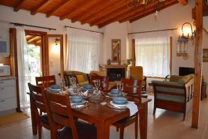 a living room with a wooden table and chairs at Zina's House in Troulos