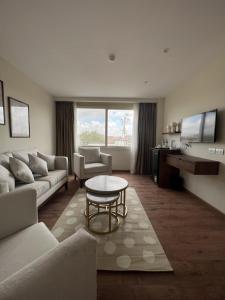 a living room with a couch and a table at The Home Boutique Hotel Pyramids Inn in Cairo