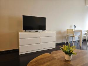 a white dresser with a television on top of it at R&F Princess Cove JB Apartment Suites By SC Homestay in Johor Bahru